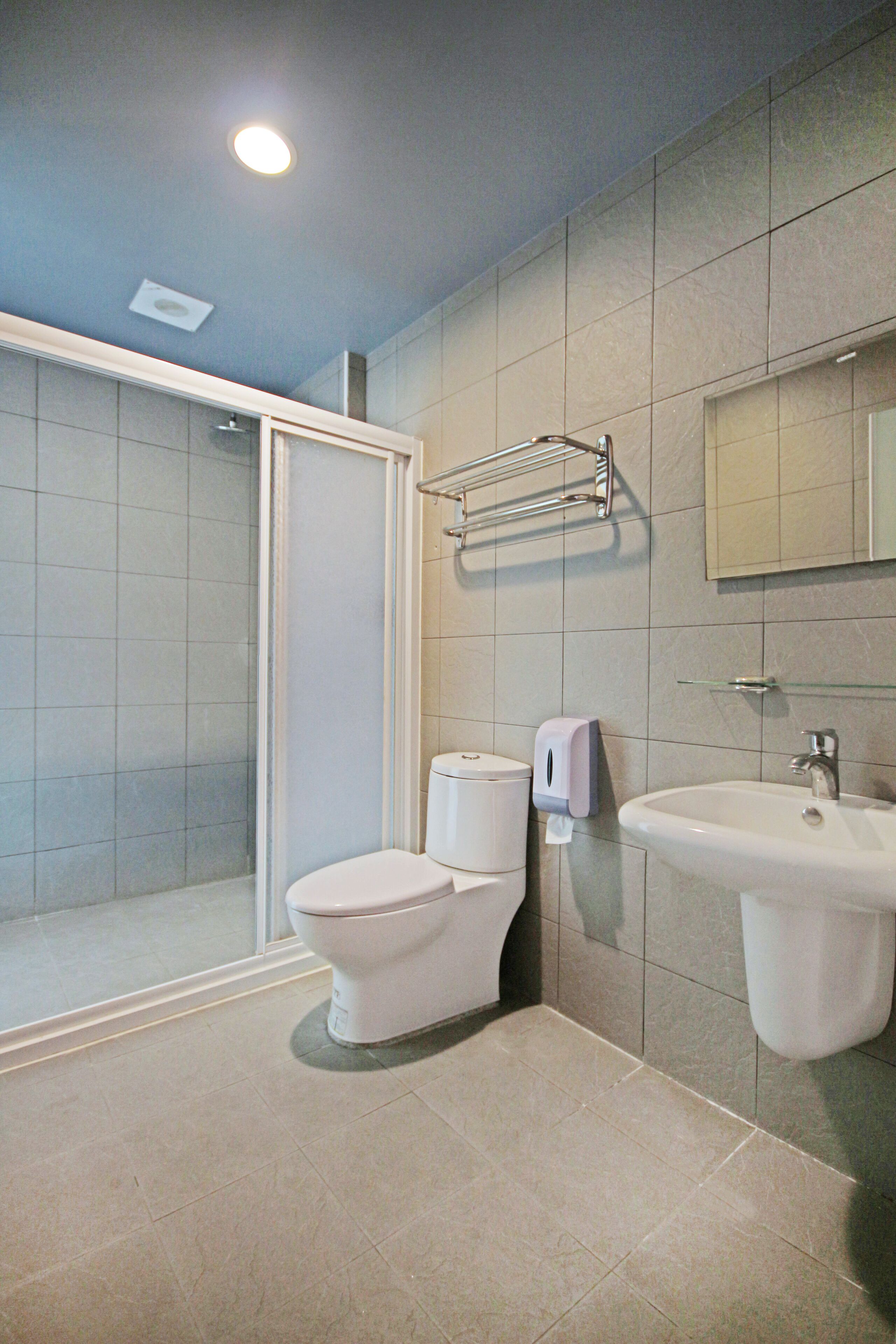 shower, hair dryer, shampoo, toilet paper