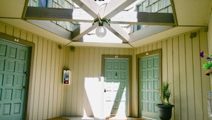 A covered porch with a ceiling fan, two doors labeled 43 and 44, and a potted plant. - Spacious, upgraded Condo in Sierra Park Villas (Mammoth Lakes)