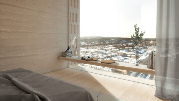 Un dormitorio moderno con un ventanal grande, una cama, una mesita de noche con libros y una lámpara, y vistas a un paisaje urbano.