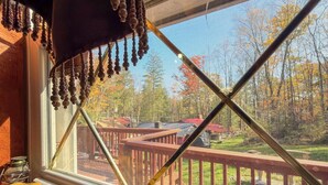 A wooden bench with a carved word "Hope" and a window with a view of a backyard.