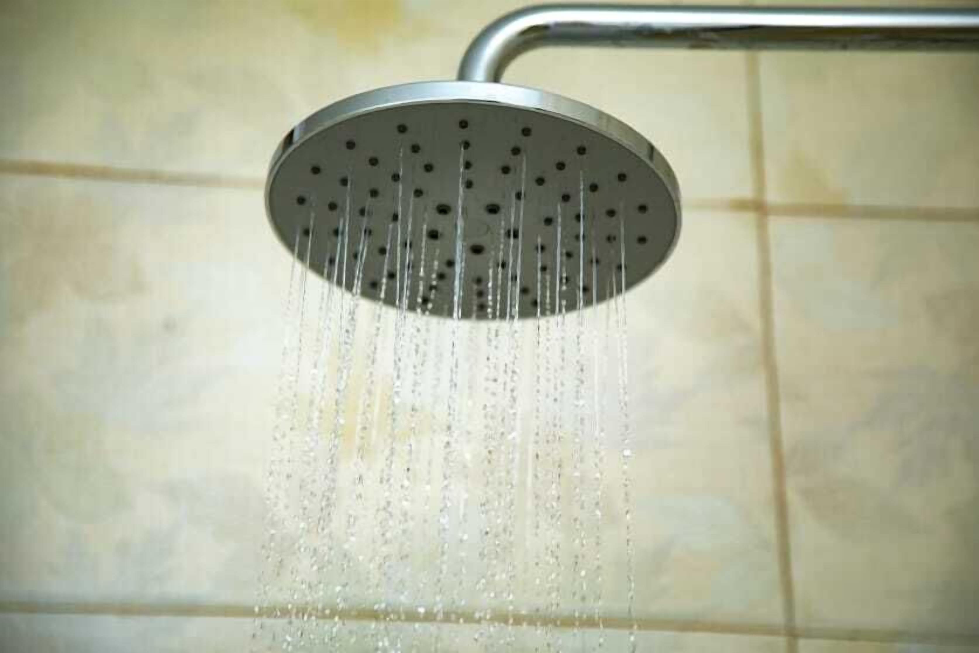A showerhead with water flowing from it.