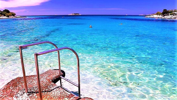 A clear blue sea with a metal railing in the foreground. - Villa Spark **** with pool in Rogoznica / Zečevo (Rogoznoca)