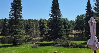 SECLUDED WOODLAND ESCAPE NEAR WISCONSIN DELLS WITH POND ON 80 PRIVATE ACRES