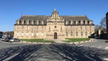 A large, historic building with a symmetrical facade, multiple windows, and a central entrance.