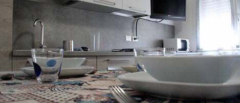 Coffee/tea maker, fridge, microwave, cookware/dishes/utensils
