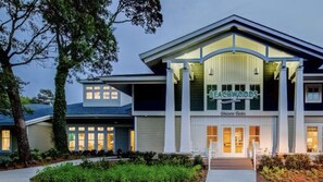 Welcome to Beachwoods, a charming two-story building with a gabled roof and large windows.