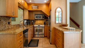 A kitchen with wooden cabinets, a granite countertop, stainless steel appliances, and a sign that reads "The Best." - Prime Central Location | 5BR | Walk to Village/Lifts | Free Parking | Managed by Aloha Whistler (Whistler)