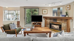 A living room with a fireplace, television, and comfortable seating.