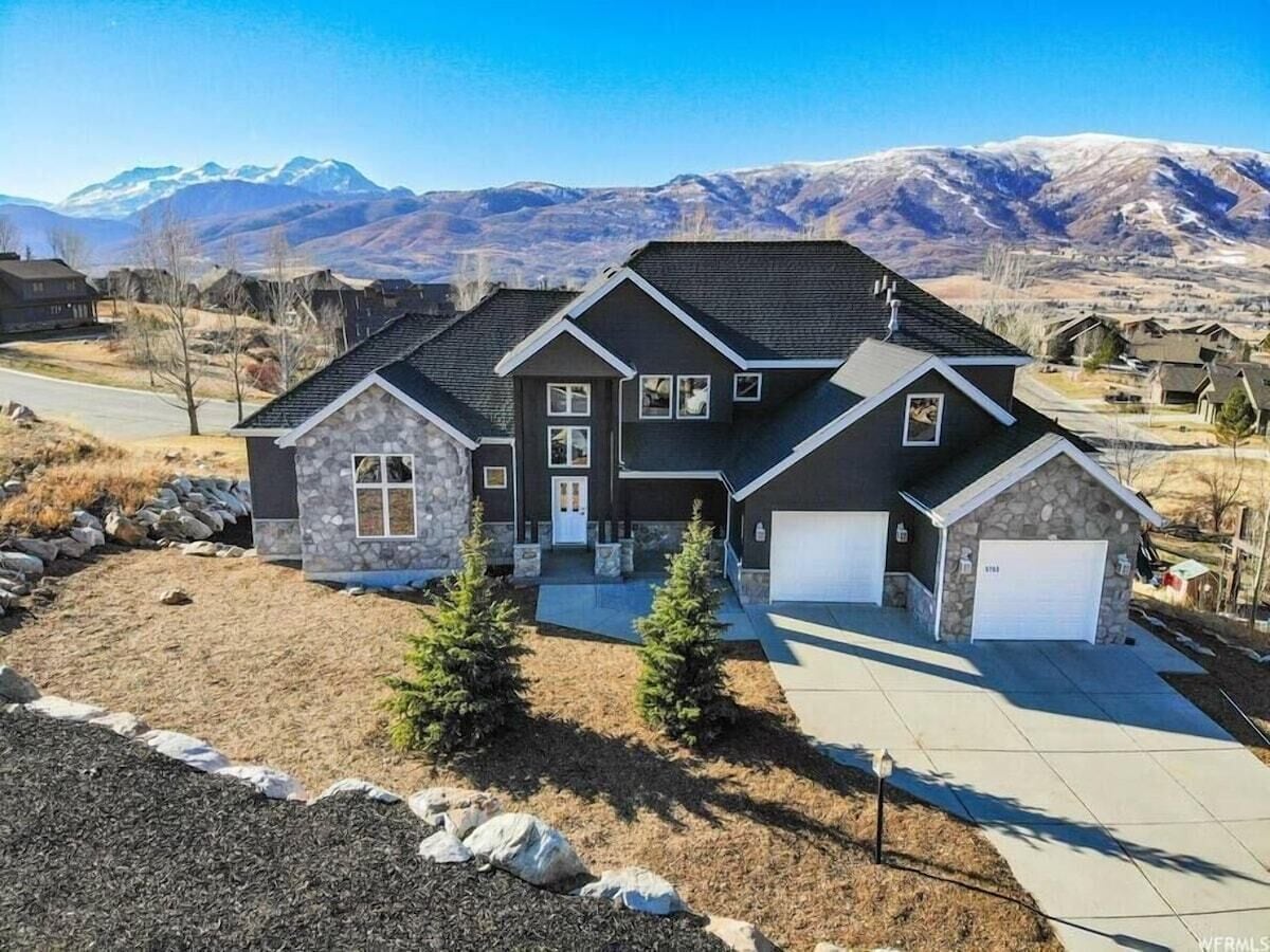 An exterior view of the home, showing the stunning mountain range!
