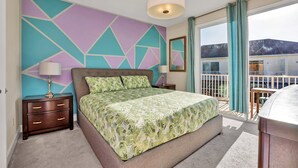 A bedroom with a bed, nightstands, and a view of the outside. - Cutest Vacation Home Ever! (Clermont)