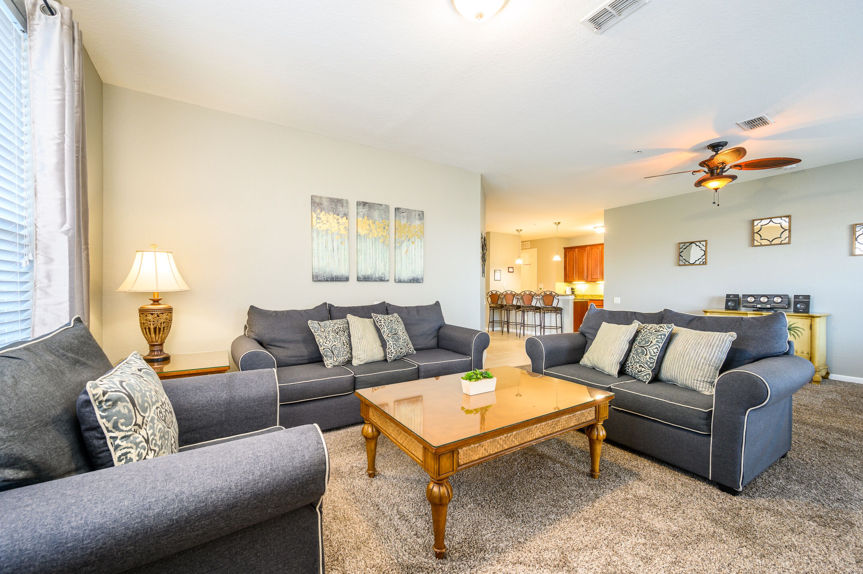 A living room with two grey sofas, a wooden coffee table, and a lamp.