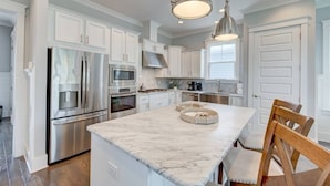A modern kitchen with stainless steel appliances, white cabinetry, and a marble island. - Current Situation| 4 Bdrm w/ 3 Kings | Heated Pool | Golf Cart (Santa Rosa Beach)