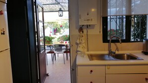 A kitchen with a sink, cabinets, and a window.