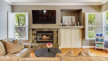 A living room with a fireplace, a sofa, and a coffee table.