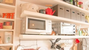 A kitchen with white cabinets, a microwave, and various kitchen utensils and appliances. - May Rooms Taipei Main Station (Taipei)