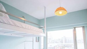 A bunk bed room with a city view, a hanging light fixture, and a window. - May Rooms Taipei Main Station (Taipei)