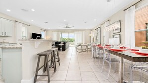 A spacious kitchen with a dining area, a large window, and a view of the outdoors.