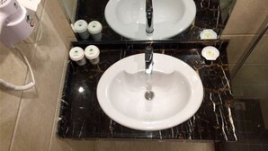 A bathroom with a white sink, a mirror above it, and toiletries on the counter. - Greentree Inn Henan Xinyang Shangcheng County Huangbaishan Road Times Shopping Mall Express Hotel (Xinyang)