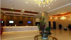 A hotel lobby with a reception desk, a chandelier, and potted plants. - Greentree Inn Henan Xinyang Shangcheng County Huangbaishan Road Times Shopping Mall Express Hotel (Xinyang)