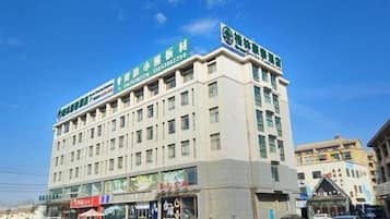 A multi-story hotel with a prominent sign on the top.