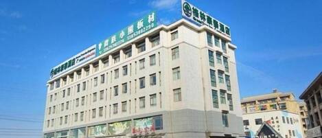 A multi-story hotel with a prominent sign on the top.