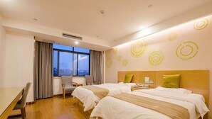 A hotel room with two beds, a desk, a chair, and a window with curtains. - Greentree Inn Bozhou Lixin District Huishang Market (Bozhou)