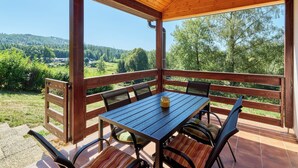 A covered outdoor seating area with a table and chairs, overlooking a scenic landscape. - Kyjov u Krásné Lípy by Interhome (Krasna Lipa)