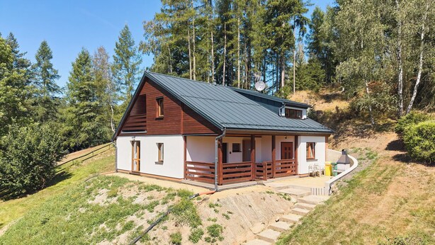 A single-story house with a sloped roof, a wooden porch, and a gravel driveway leading to the entrance. - Kyjov u Krásné Lípy by Interhome (Krasna Lipa)