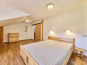 A bedroom with a wooden bed, a dresser, and a bench. - Kyjov u Krásné Lípy by Interhome (Krasna Lipa)