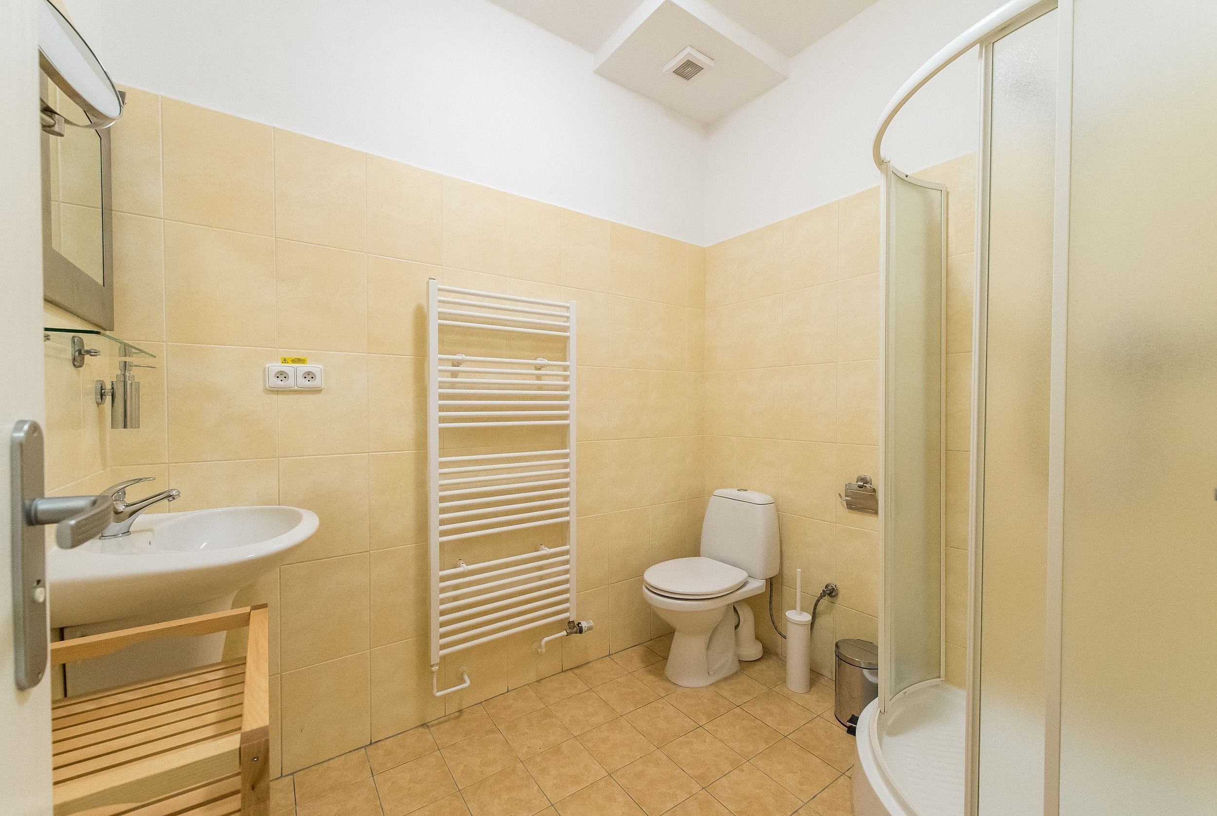 A bathroom with a sink, toilet, and shower.