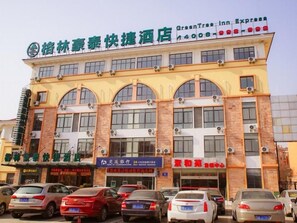 A hotel with a prominent sign for 'GreenTree Inn Express' and a visible 'Bank of Communications' sign. - Greentree Inn Wuxi Yixing Xushe Town Government Ex (Wuxi)