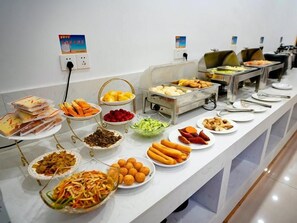A buffet with various food items including fruits, vegetables, and prepared dishes. - Greentree Inn Wuxi Yixing Xushe Town Government Ex (Wuxi)