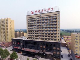 A multi-story hotel with a prominent sign at the top.