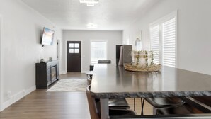 A modern kitchen with a long countertop, dark wooden cabinets, and a built-in oven. - Newly Re-Finished 2 bed, 1 bath close to downtown (Sheridan)