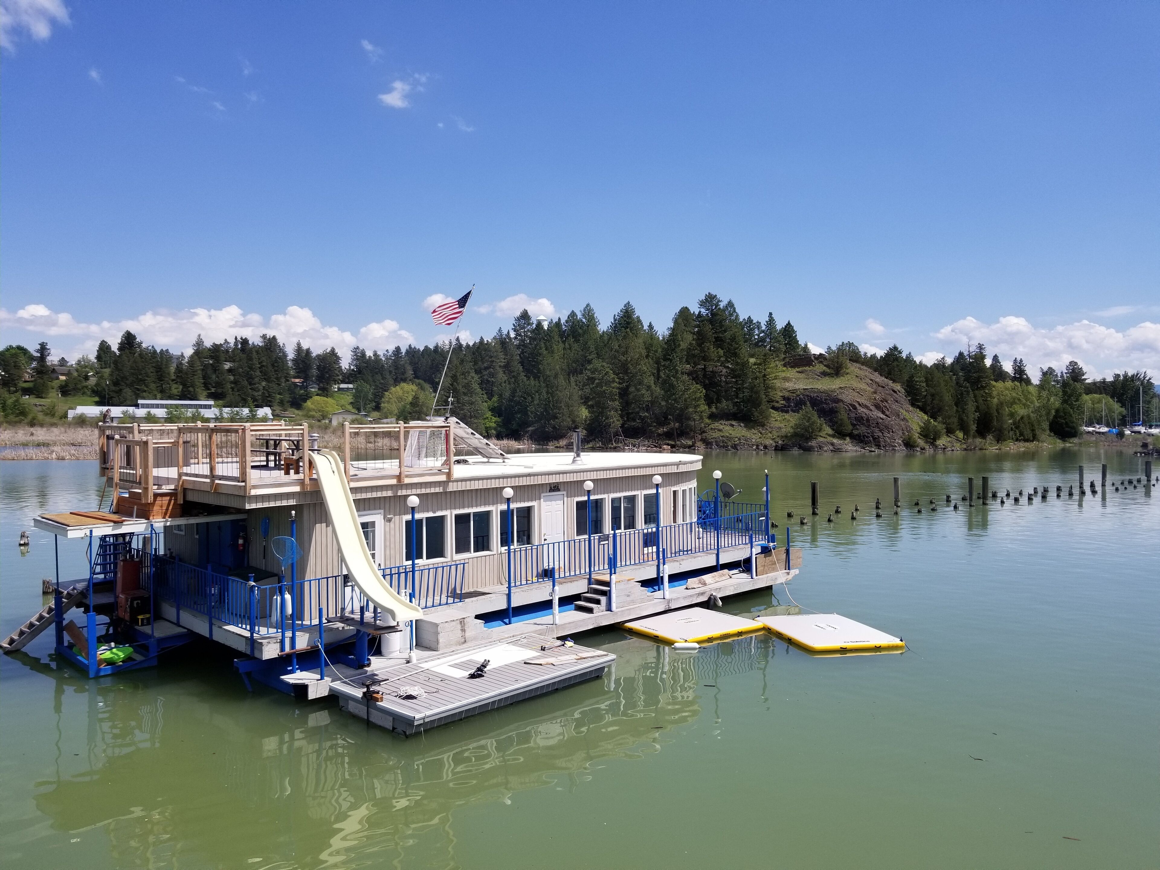 FLOATING HOUSE on Flathead Lake with waterslide, kayaks, rooftop deck, and more