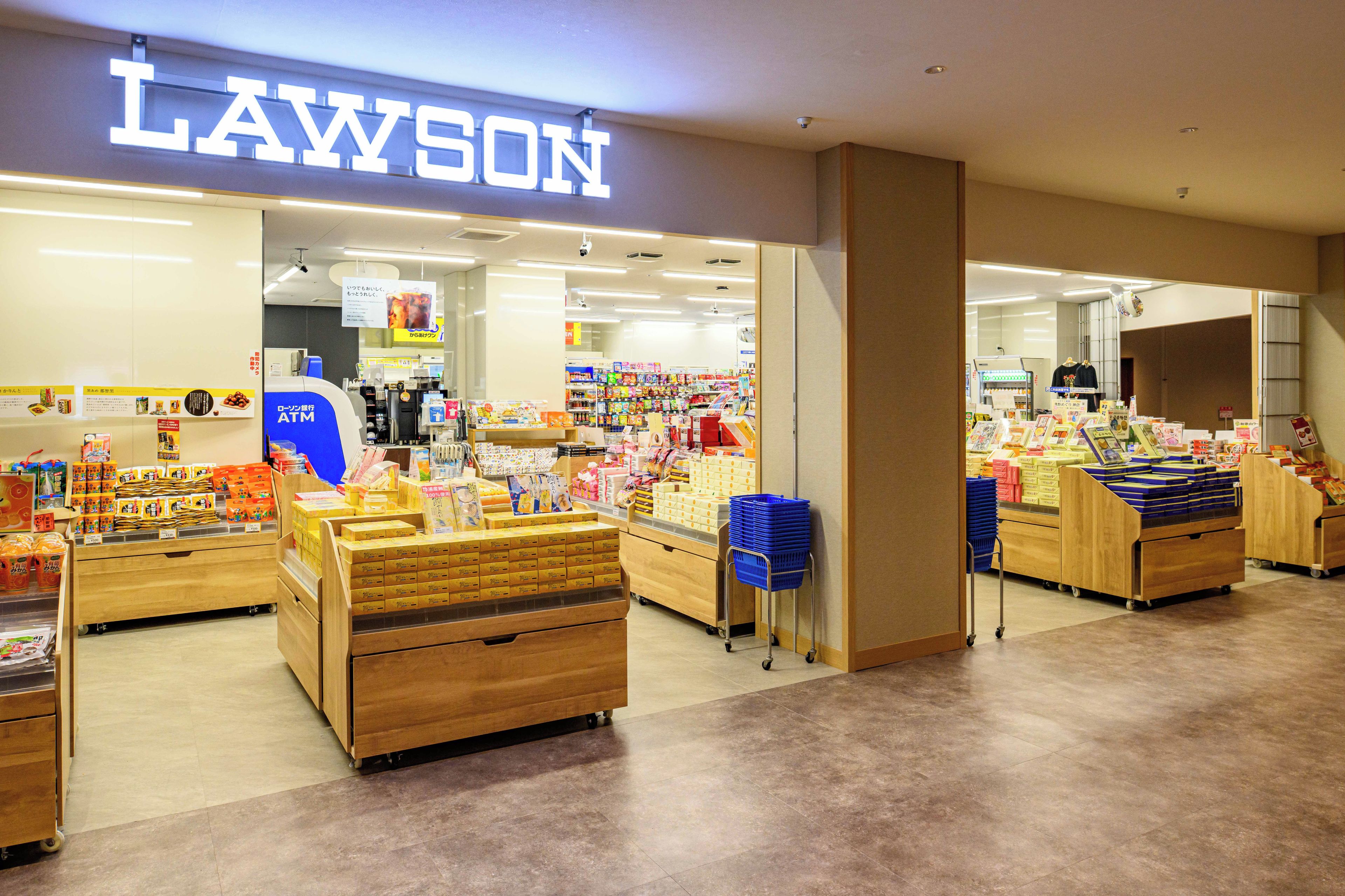 A Lawson convenience store with a variety of products on display and a visible ATM.