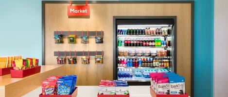 A grocery store display with snacks, drinks, and packaged goods.