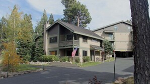 A two-story building with a balcony, a flag, and a sign that reads "Chateau." - Crestview 30: Free EV Charger, Walk to The Village (Mammoth Lakes)
