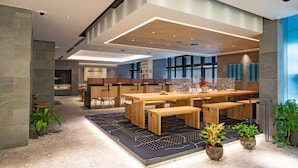 A modern kitchen with wooden countertops, a central island, and a dining area with benches.