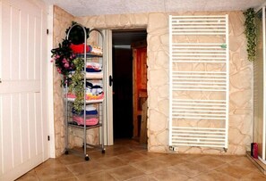 Comfortable room with a stone wall, white door, and brown tile floor.
