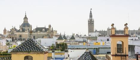 A cityscape with historic buildings, including a prominent tower and a church with a dome.