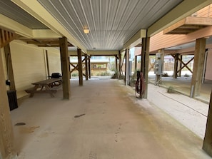 Enjoy meals at a picnic table in this open space with a concrete floor and wooden beams.