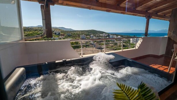 A hot tub with a view of a coastal landscape.