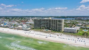 A large hotel with multiple floors and a beachside location.
