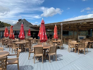 Enjoy dining al fresco on the deck, surrounded by comfortable seating and shade from the pergola.