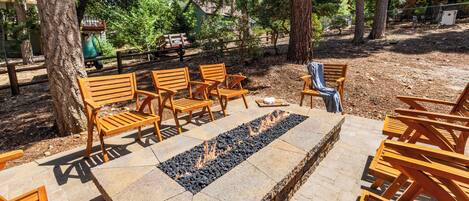 An outdoor seating area with wooden benches and a fire pit.