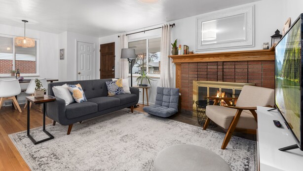 A living room with a fireplace, a sofa, a TV, and a coffee table.