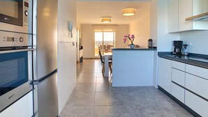 A modern kitchen with built-in appliances, a central island, and pendant lighting. - 3071 Vista Azul XXIX 3071 (Orihuela Costa)