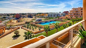 A residential area with a swimming pool, palm trees, and a view of the cityscape. - 3071 Vista Azul XXIX 3071 (Orihuela Costa)
