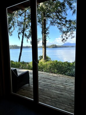 A wooden deck with a view of a lake and trees. - Coastal View-Rated top place to stay on the inlet! (Tofino)